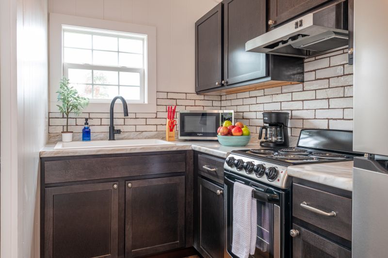 full kitchen with sink, microwave, coffeemaker, toaster, stove and refrigerator