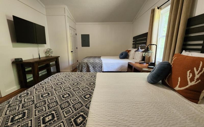 separate bedroom with two queen beds, dresser and television