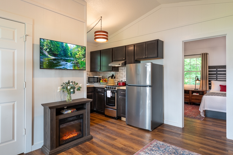living area with electric fireplace and full kitchen