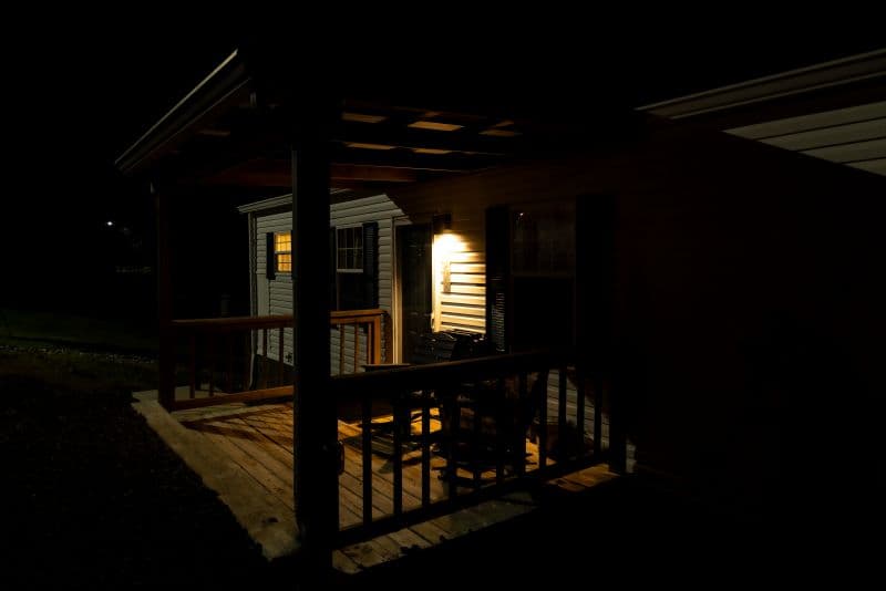 cabin porch at night with a light on
