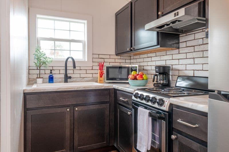 full kitchen with sink, microwave, coffeemaker, toaster, stove and refrigerator