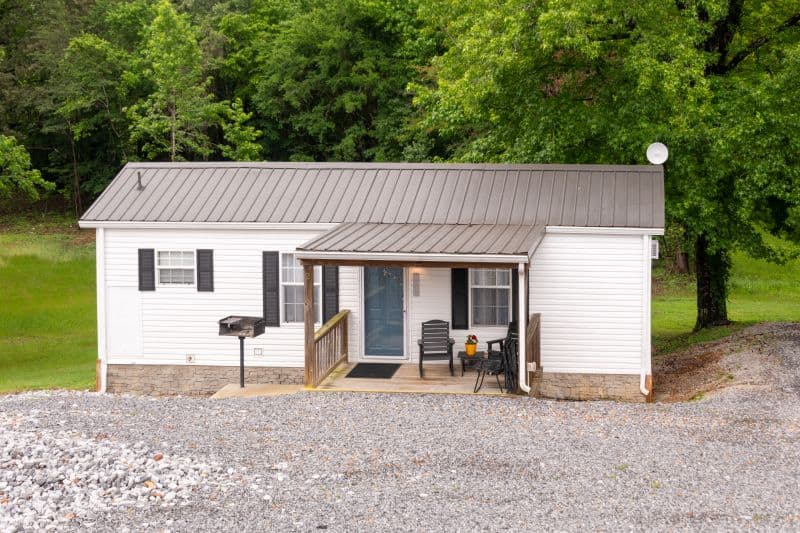 white cabin with porch and no stairs