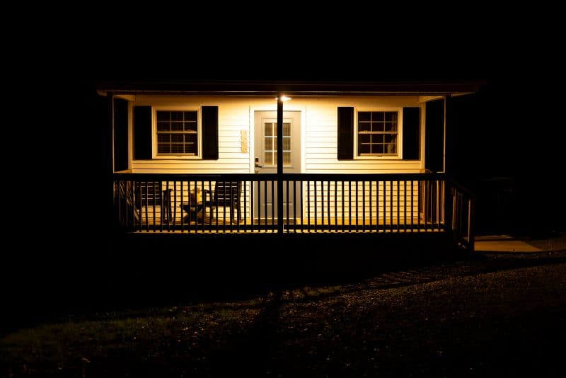 cabin porch at night with a light
