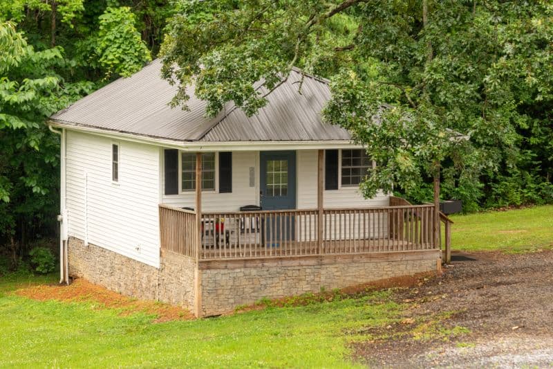 white cabin with porch and side entry