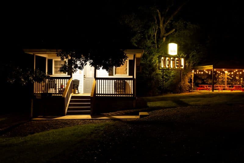 cabin and porch at night with a light and pavilion next to it