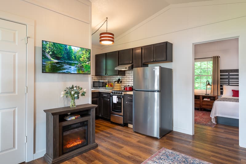 living area with electric fireplace and full kitchen