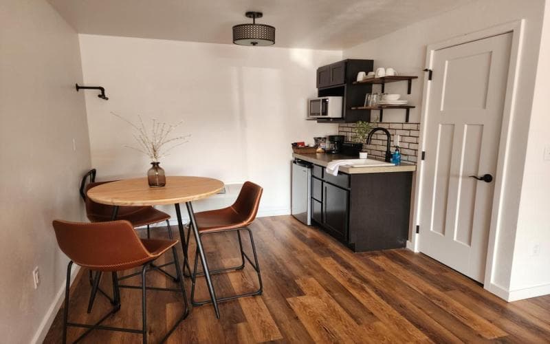 kitchenette area with counter height table and three stools