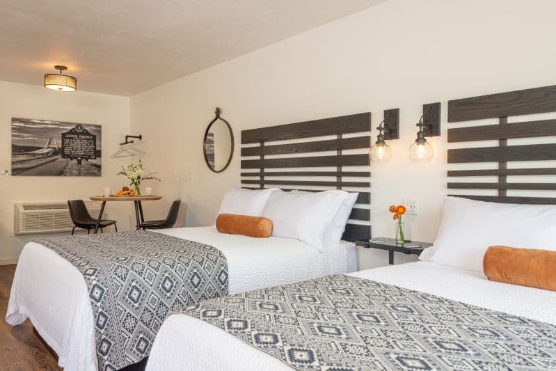 two queen beds with a dining area