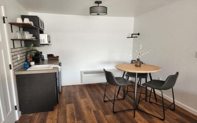 kitchenette with counter height table and three stools