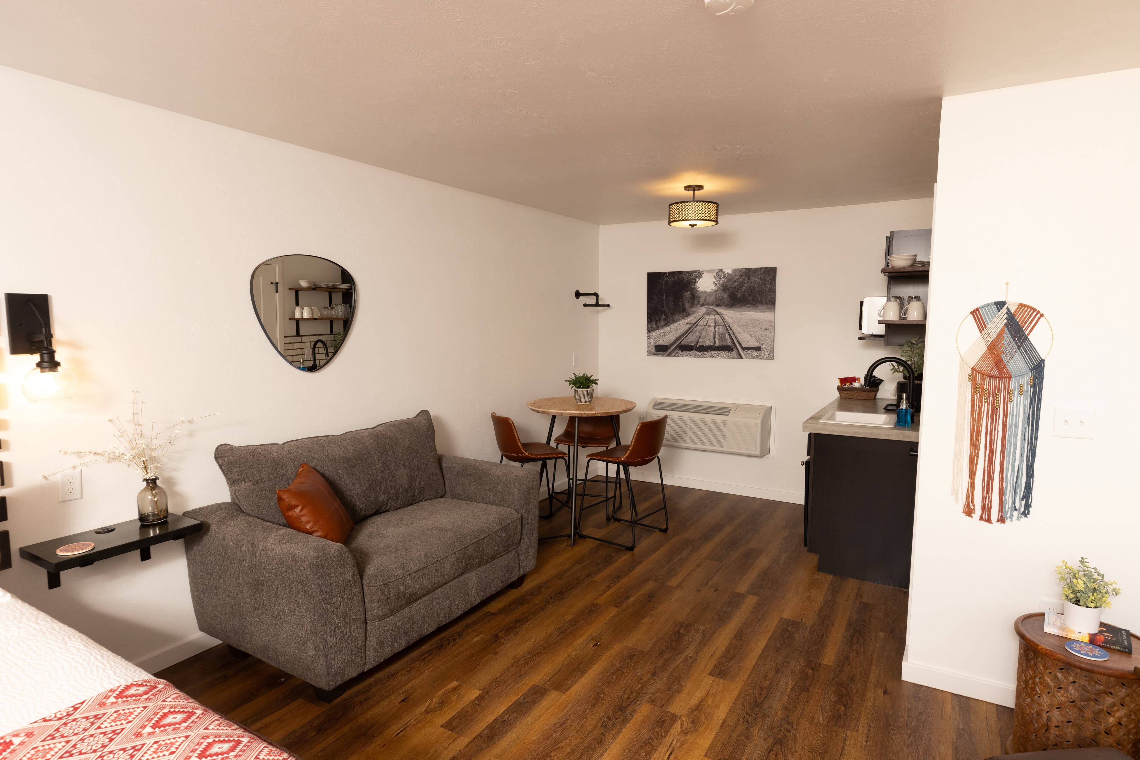 hotel room with kitchenette, seating and large chair