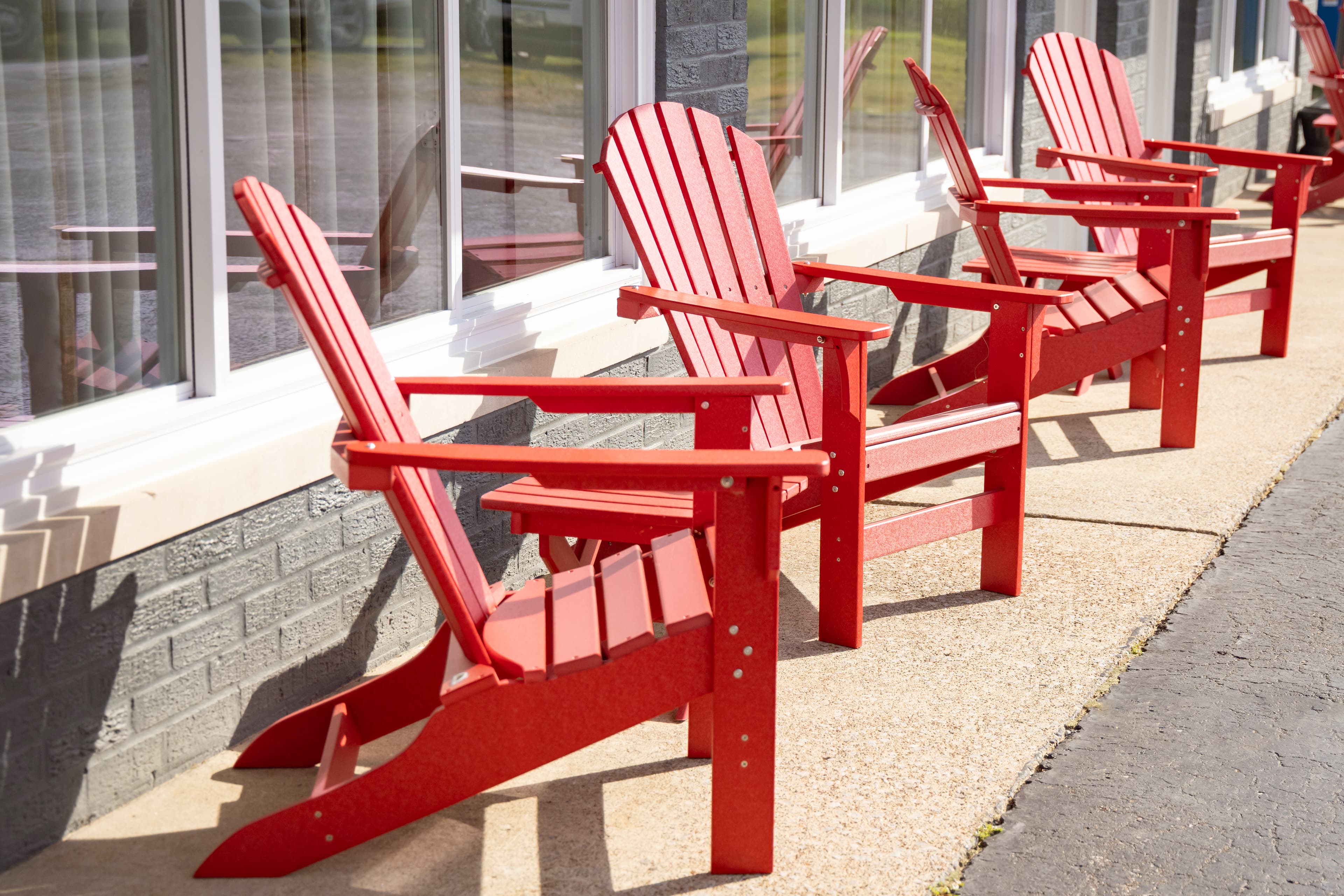 red patio chairs in front of a brick hotel room