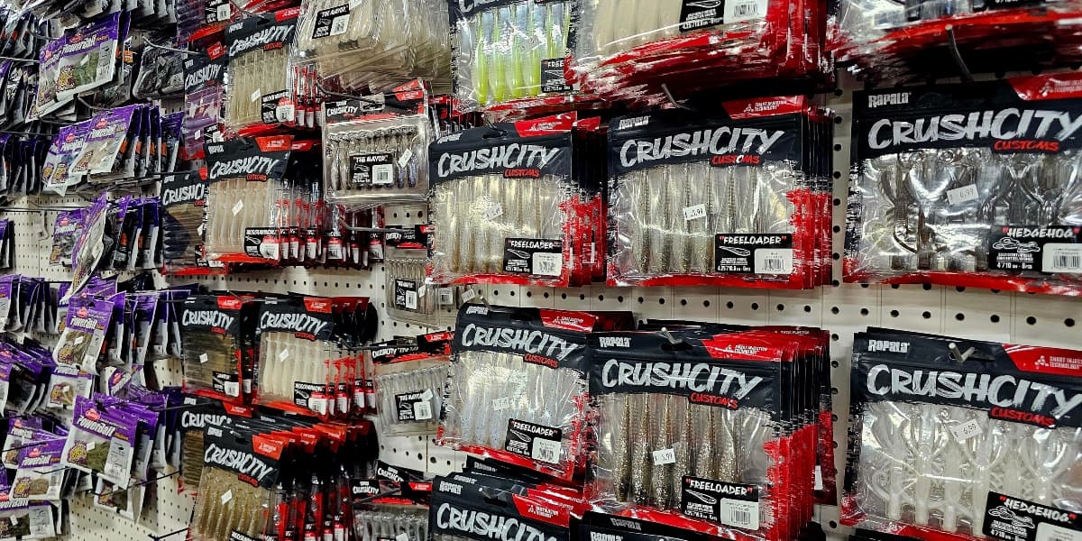 Shelves stocked with various fishing lures and baits in packaging.