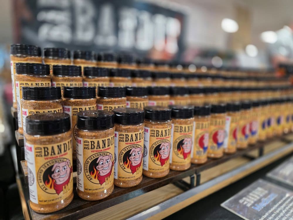 A shelf displays multiple jars of seasoning labeled "BBQ Bandit."