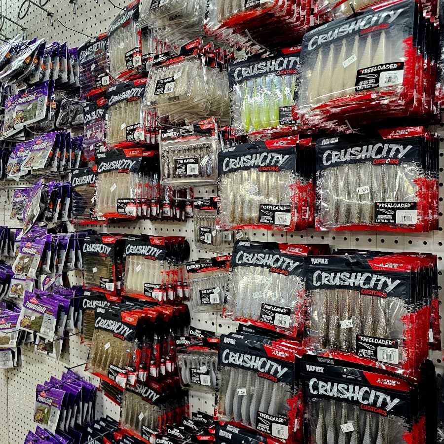 A display shelf filled with various fishing lures in colorful packaging.