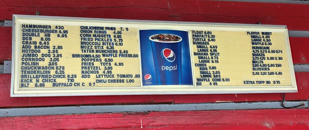 A food menu displaying various items and prices alongside a Pepsi advertisement.