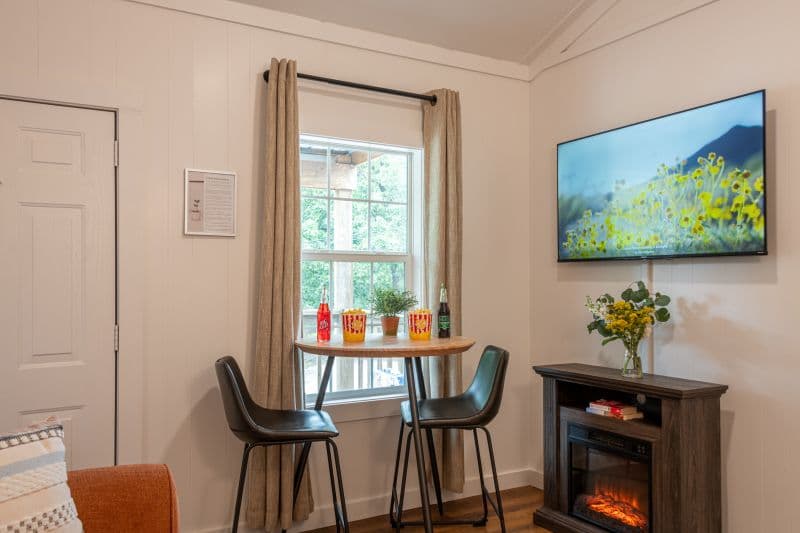dinette set, electric fireplace and wall mounted tv