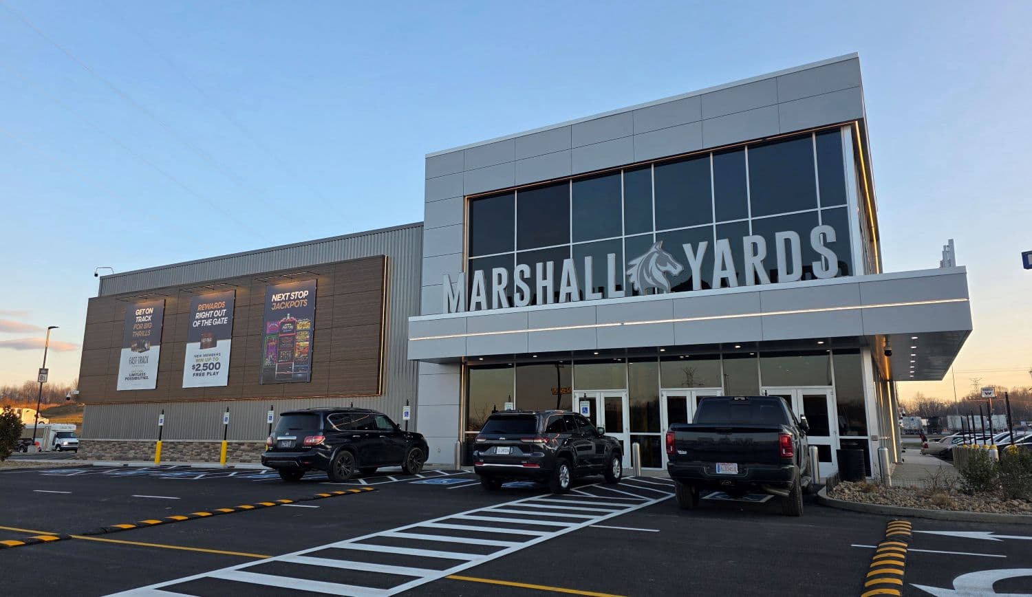 Exterior view of the Marshall Yards building showcasing the entrance and parked cars.