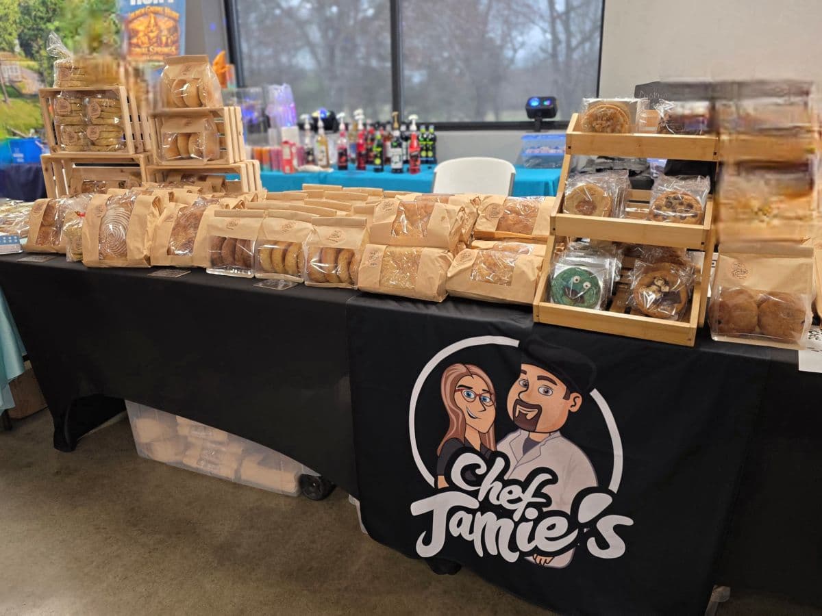 A display of assorted baked goods on a table with a "Chef Jamie's" banner.